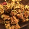 Von DinaFem Seeds Industrial Plant.Close-up of multiple dried cannabis buds with visible trichomes and orange pistils.